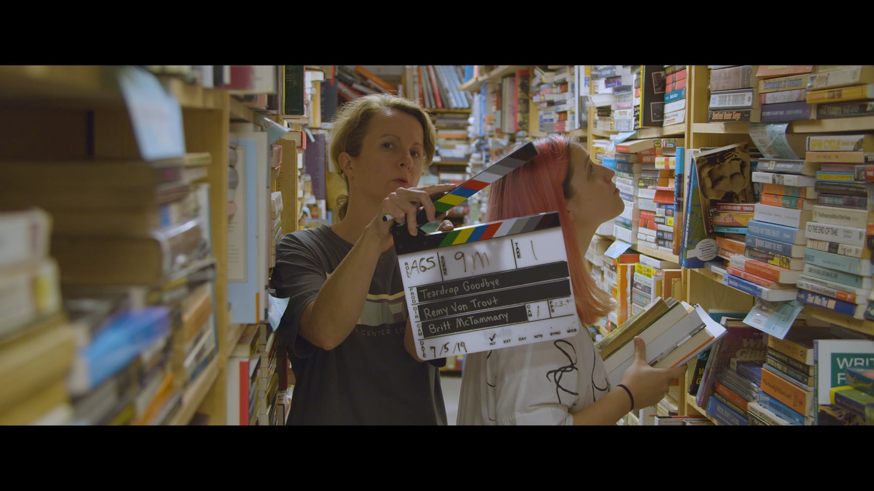 Grace H Bryan holding a film clapper on set